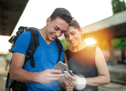 Man and woman check information on phone